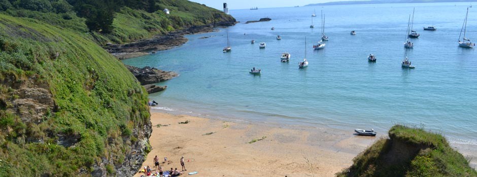 people and boats at Great Molunan beach on St Anthony's headland