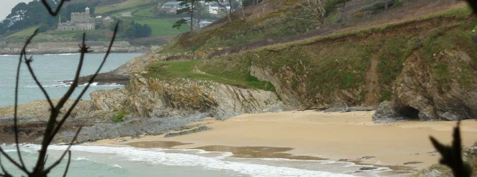 a deserted Great Molunan beach at St Anthony's headland with St Mawes behind