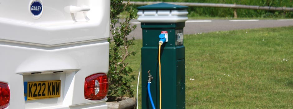 caravan connected to a service bollard on a Premium pitch