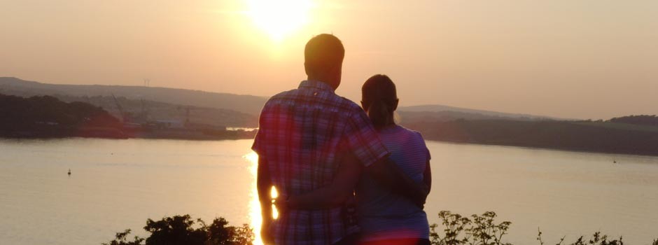 couple enjoying the sunset over the Carrick Roads