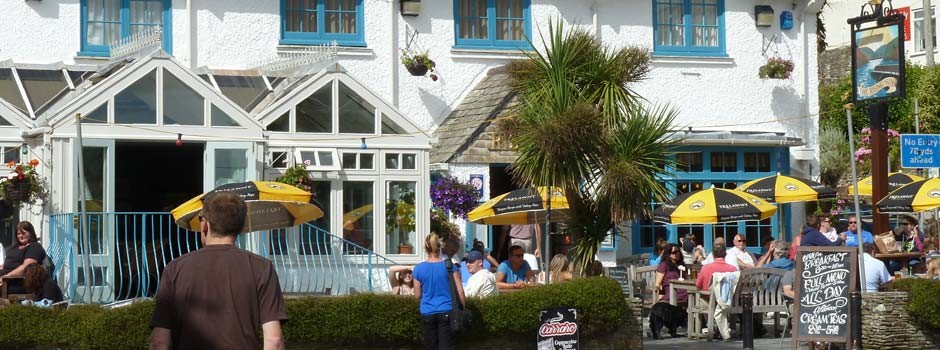 people sat at tables outside the Rising Sun pub in St Mawes