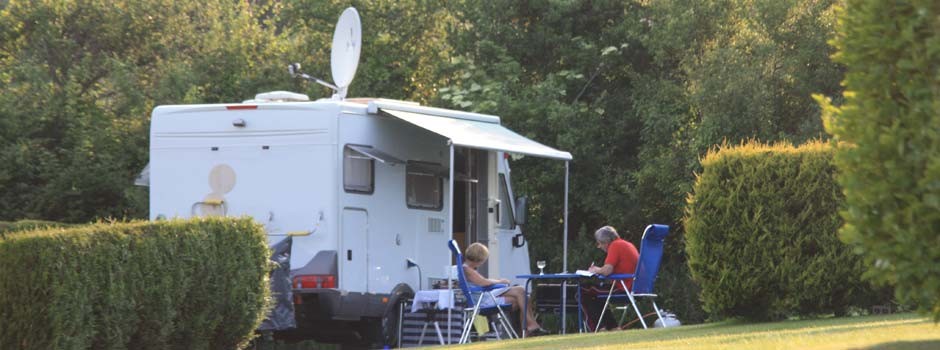 people sat outside a motorhome on pitch 14