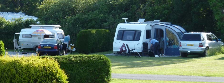 people busy outside their caravans on pitches 22 and 23