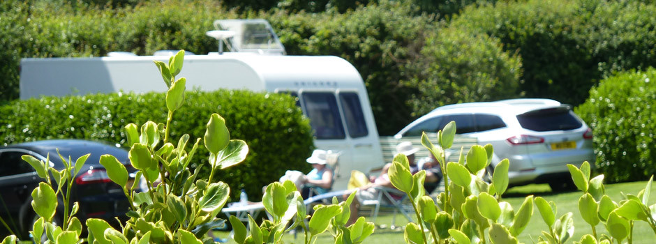 people outside a caravan and awning on pitch 60