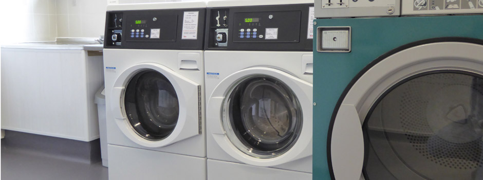 washing machines, tumble dryers and sink in the laundrette